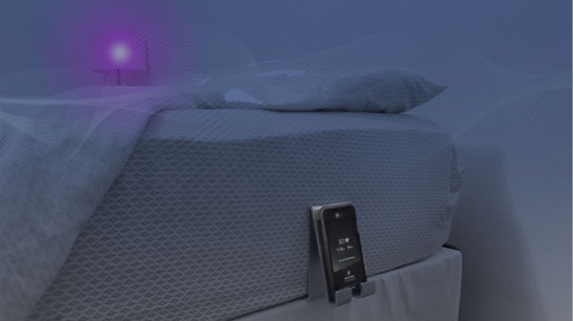 Picture of the SleepSpace Smart Bed in use where it is also controlling the brightness of a light and playing soothing sounds.